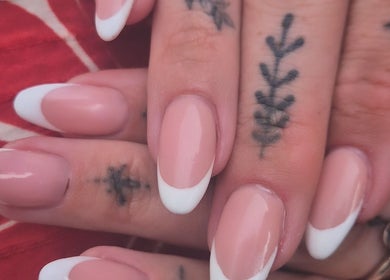Elegant French manicure with tattoos at Oliviabeautè, Eastbourne, England, GB.