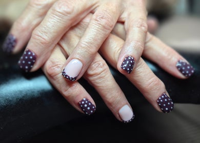 Stylish polka dot manicure from Oliviabeautè in Eastbourne, England, GB. Perfect nail art for modern elegance.