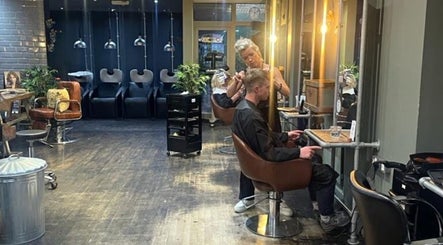 Jo Gulliford Hairstylist at work in a sleek salon in Brighton And Hove, GB, offering expert haircuts.