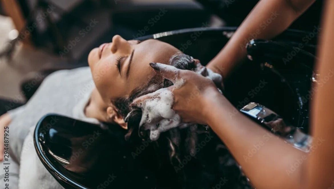 Relaxing hair wash at Virtuosity, Al Hidd, Muḥāfaẓat Al-muḥarraq, BH, showcasing premium salon care.