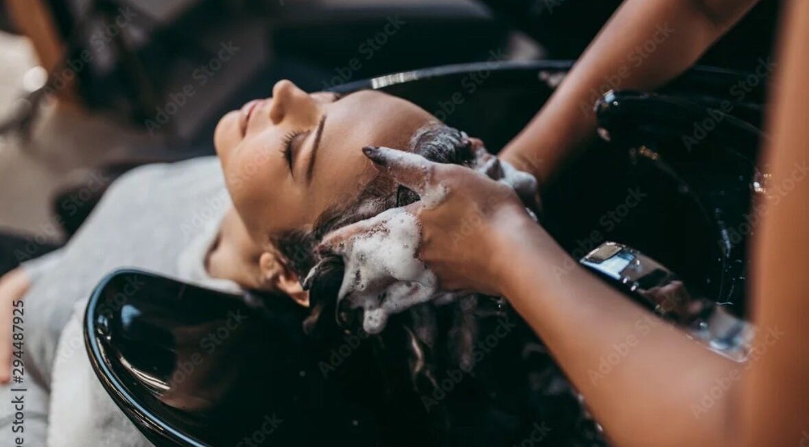 Relaxing hair wash at Virtuosity, Al Hidd, Muḥāfaẓat Al-muḥarraq, BH, showcasing premium salon care.