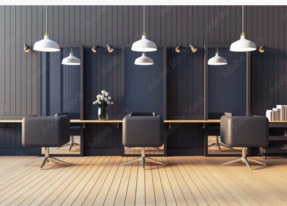 Elegant salon setup at Virtuosity, Al Hidd, Muḥāfaẓat Al-muḥarraq, BH featuring sleek chairs and modern lighting.