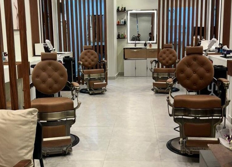 Astur Barbershop, Riyadh Province, SA, featuring luxurious brown leather chairs.
