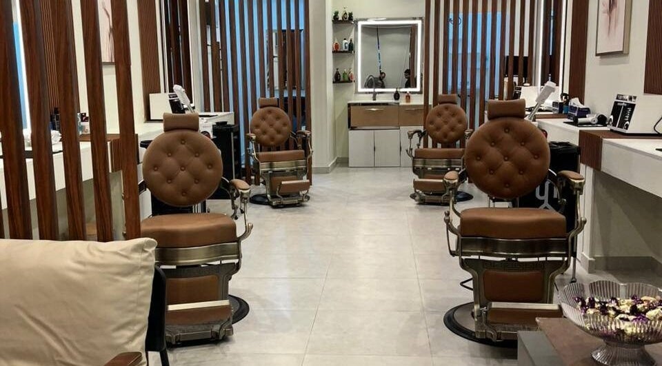 Astur Barbershop, Riyadh Province, SA, featuring luxurious brown leather chairs.