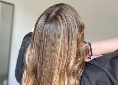 Shiny, highlighted hair at Blended Hair & Wellness, Hounslow, England, GB, showcasing professional styling.
