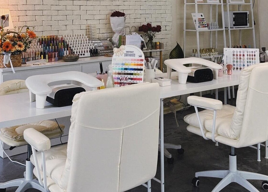 Elegant nail studio at YIN Nails and Lashes, Krung Thep Maha Nakhon. Stylish white decor and nail colors on display.