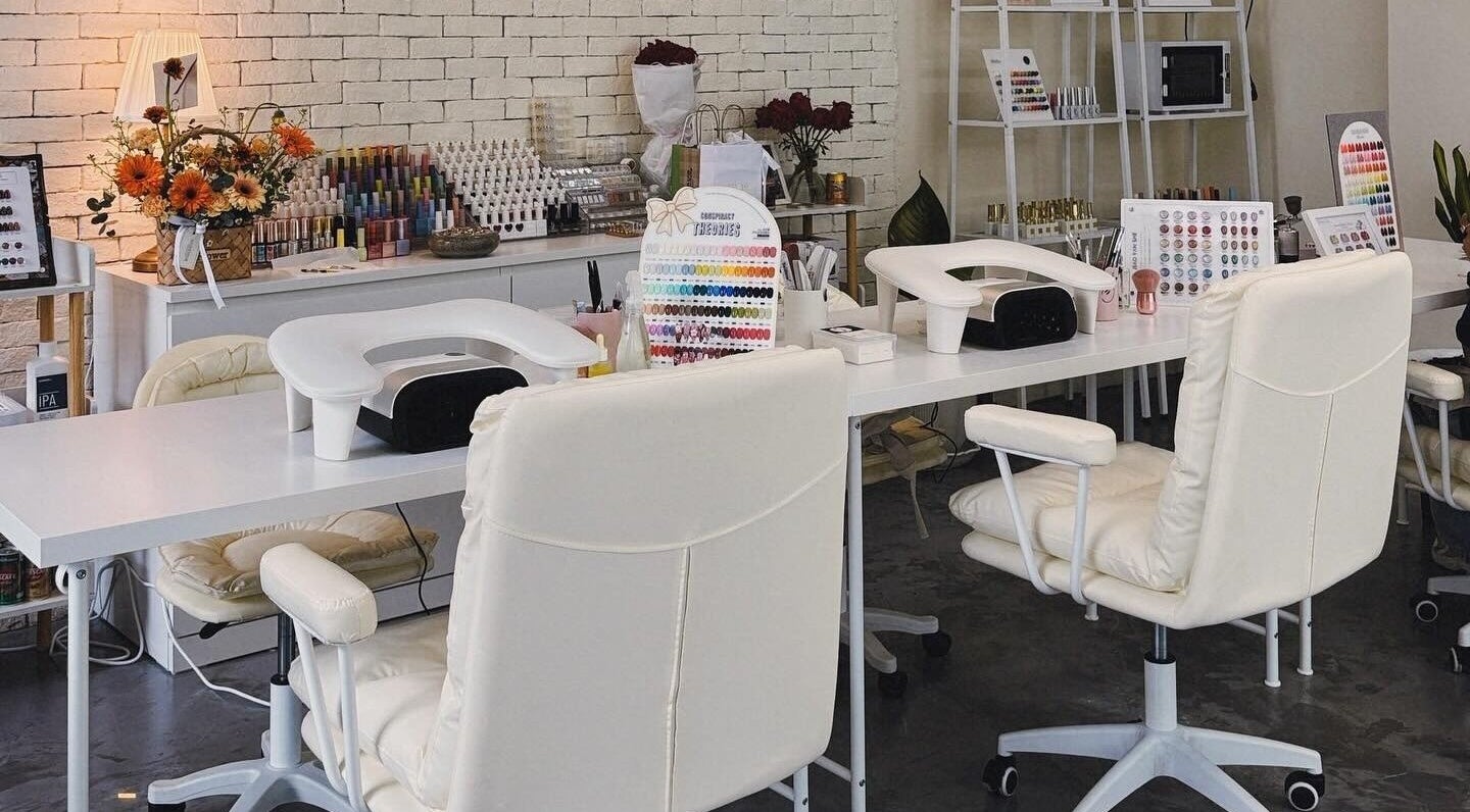 Elegant nail studio at YIN Nails and Lashes, Krung Thep Maha Nakhon. Stylish white decor and nail colors on display.