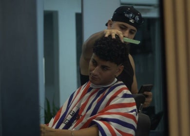 Barber styling a client's hair at Alberto's Barber and Wellness Hub, Gzira, MT.