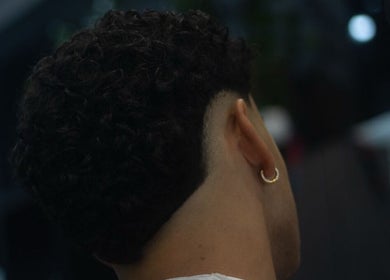 Curly fade hairstyle at Alberto's Barber and Wellness Hub, Gzira, MT. Modern grooming for men.