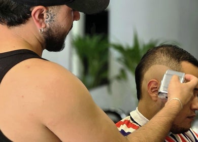 Barber gives a stylish haircut at Alberto's Barber and Wellness Hub in Gzira, MT.