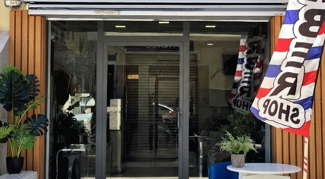 Stylish entrance of Alberto's barber shop in Gzira, MT, with modern decor and welcoming signage.