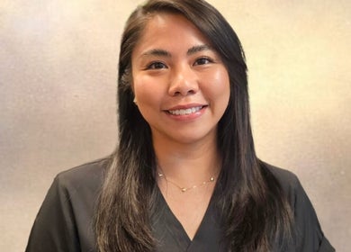 Smiling staff member at Mae Medical Aesthetics, London, England, GB, enhancing client experience.