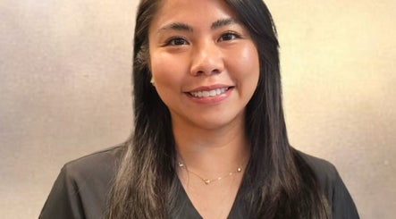 Smiling staff member at Mae Medical Aesthetics, London, England, GB, enhancing client experience.