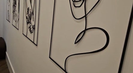 Intricate line art decorates the walls of Mae Medical Aesthetics in London, England, GB, creating a serene ambiance.