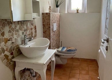Elegant restroom at The Wax Room in Weiden In Der Oberpfalz, Bayern, DE with mosaic tiles and a modern basin.