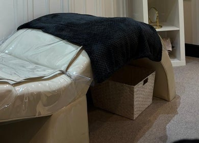 Cozy treatment room at Rebel Beauty in Burnley, England, GB, featuring a plush bed and calming decor.