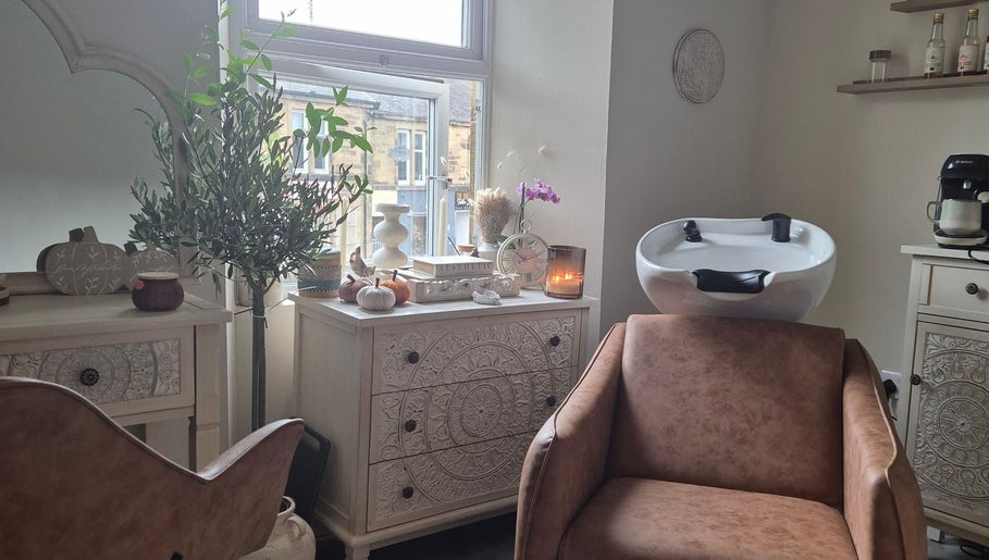 Elegant beauty salon room at Wild Aura Denny in Denny, Scotland, GB, showcasing stylish decor and hair washing station.
