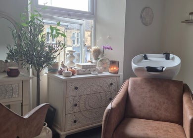 Elegant beauty salon room at Wild Aura Denny in Denny, Scotland, GB, showcasing stylish decor and hair washing station.