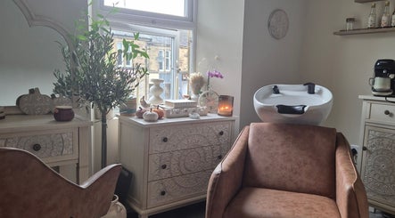 Elegant beauty salon room at Wild Aura Denny in Denny, Scotland, GB, showcasing stylish decor and hair washing station.