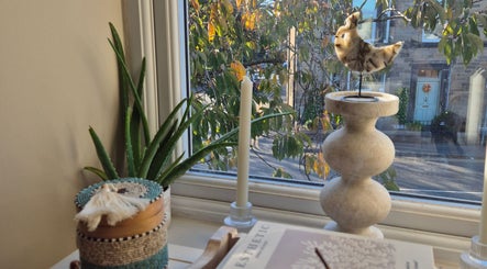 Cozy window nook at Wild Aura Denny with decor and view of Denny, Scotland, GB.