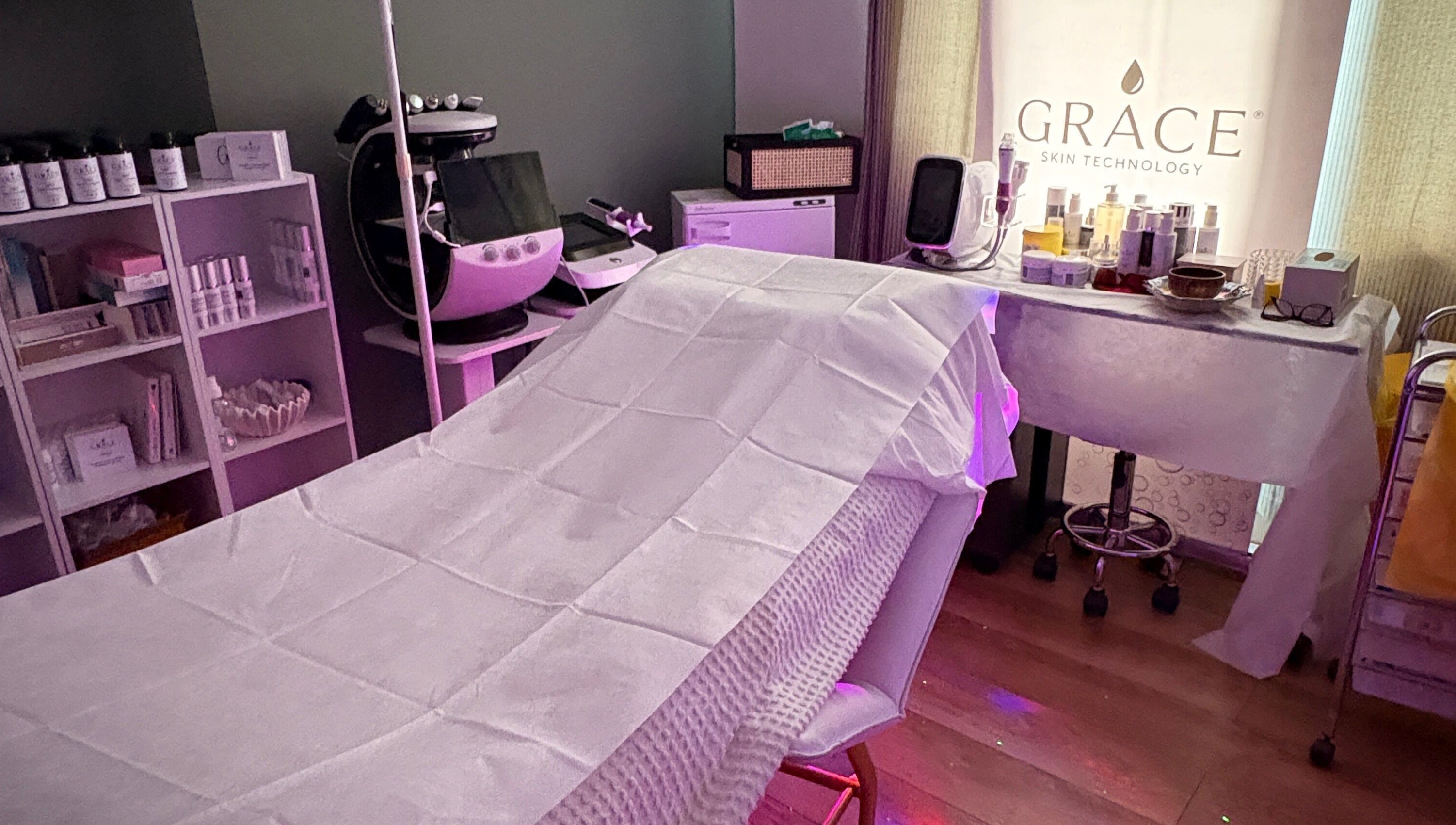Spa room at GRACE SKIN TECHNOLOGY, Cranleigh, England, GB, showcasing a relaxing treatment bed and skincare products.