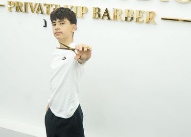 Young barber showcasing scissors at MertzBlendz, London, England, GB.