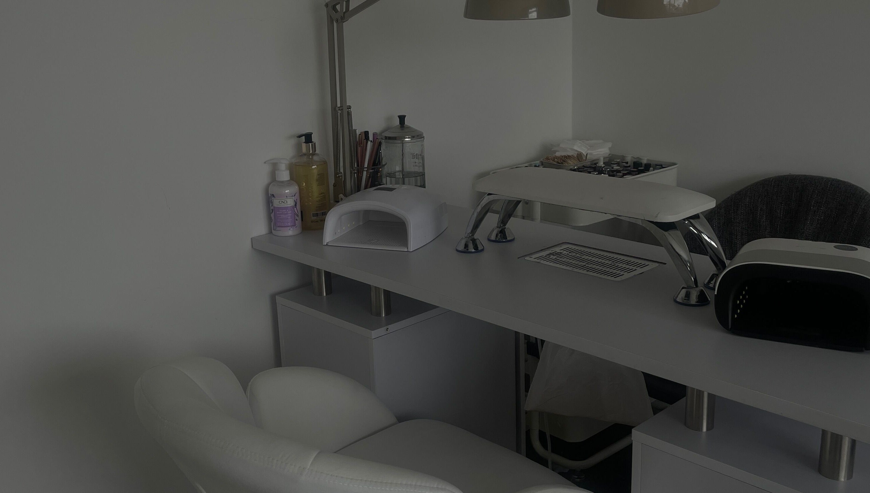 An elegant manicure station at Anas nails, London, England, GB featuring tools and a comfortable chair.