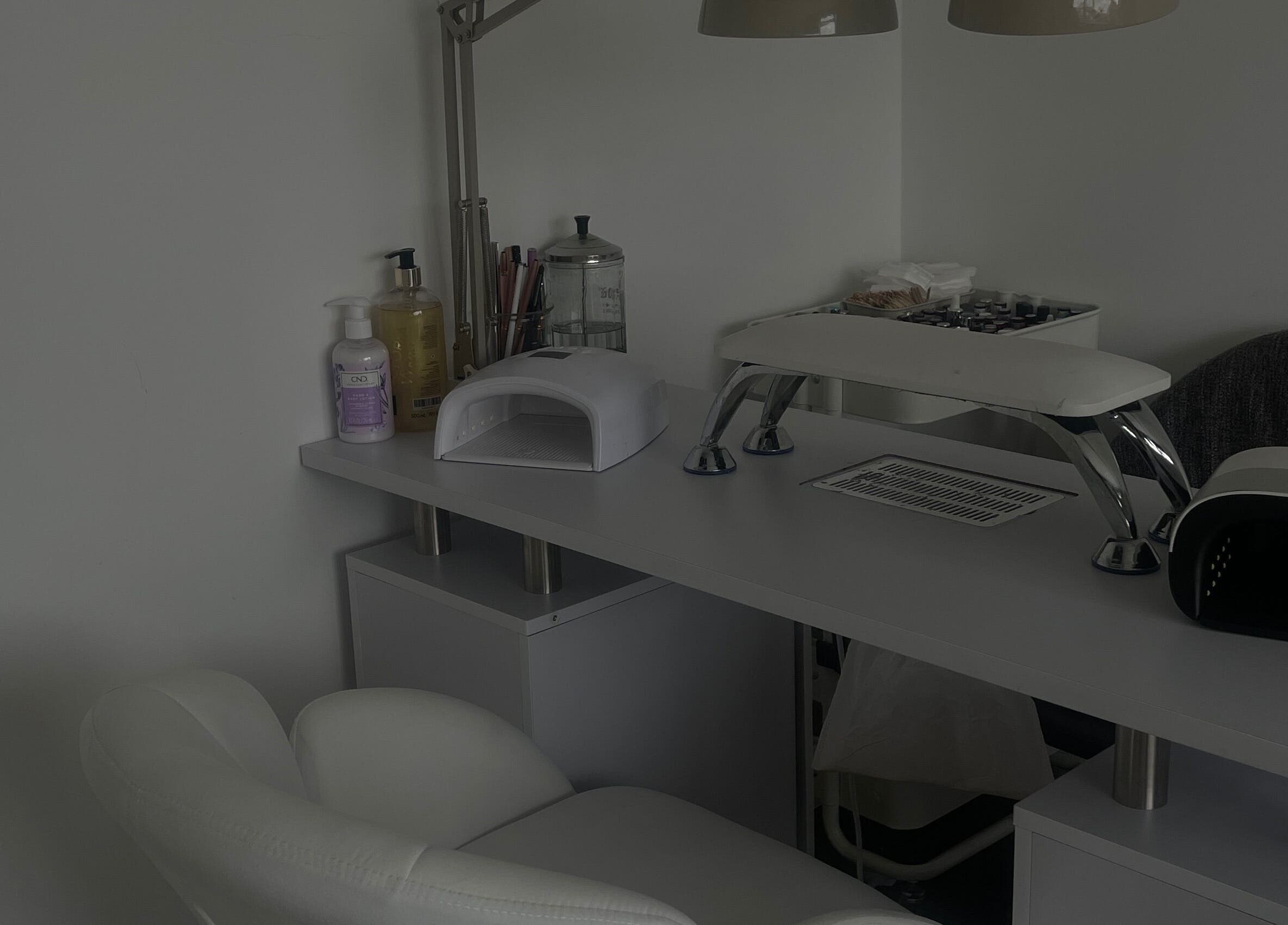 An elegant manicure station at Anas nails, London, England, GB featuring tools and a comfortable chair.