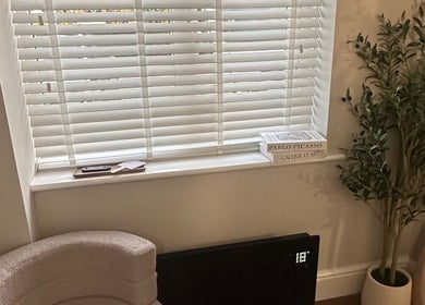 Cozy corner at El Emery Makeup & Beauty, Stafford, England, featuring a plush chair and greenery.