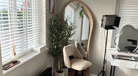 Cozy makeup chair and mirror at El Emery Makeup & Beauty, ST21 6JU, England, GB, bathed in natural light.