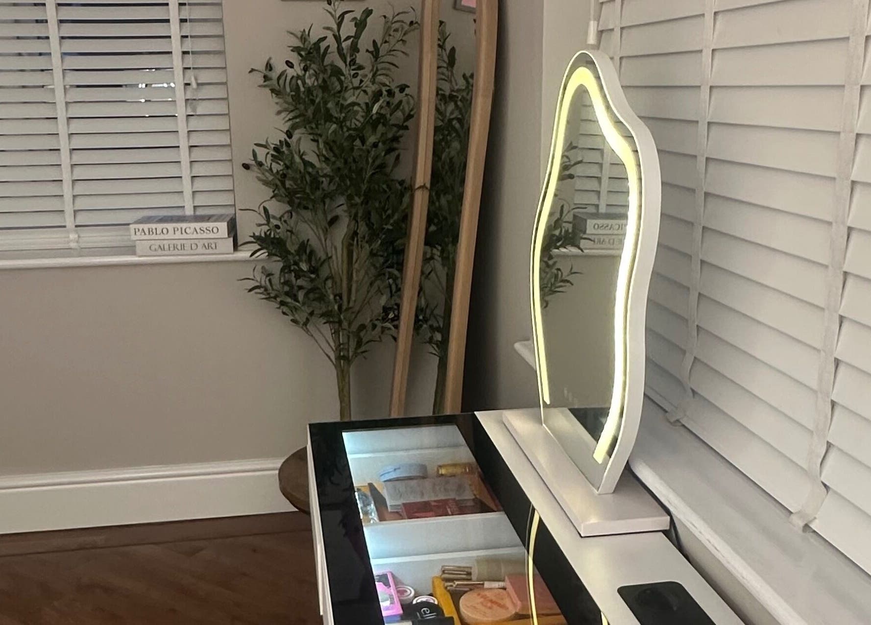 Elegant vanity with illuminated mirror at El Emery Makeup & Beauty, ST21 6JU, England, GB.