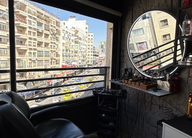 View of bustling Nablus street from Abu Al Naser Salon, featuring modern decor and beauty products.