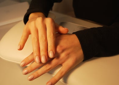 Elegant manicured hands at Bebella, Avoca Beach, New South Wales, AU, showcasing natural beauty.