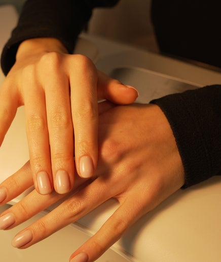 Elegant manicured hands at Bebella, Avoca Beach, New South Wales, AU, showcasing natural beauty.