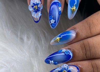 Elegant blue floral nail art by Beautiful Beginnings Nail Salon in Kingstown, VC.