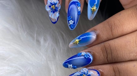 Elegant blue floral nail art by Beautiful Beginnings Nail Salon in Kingstown, VC.