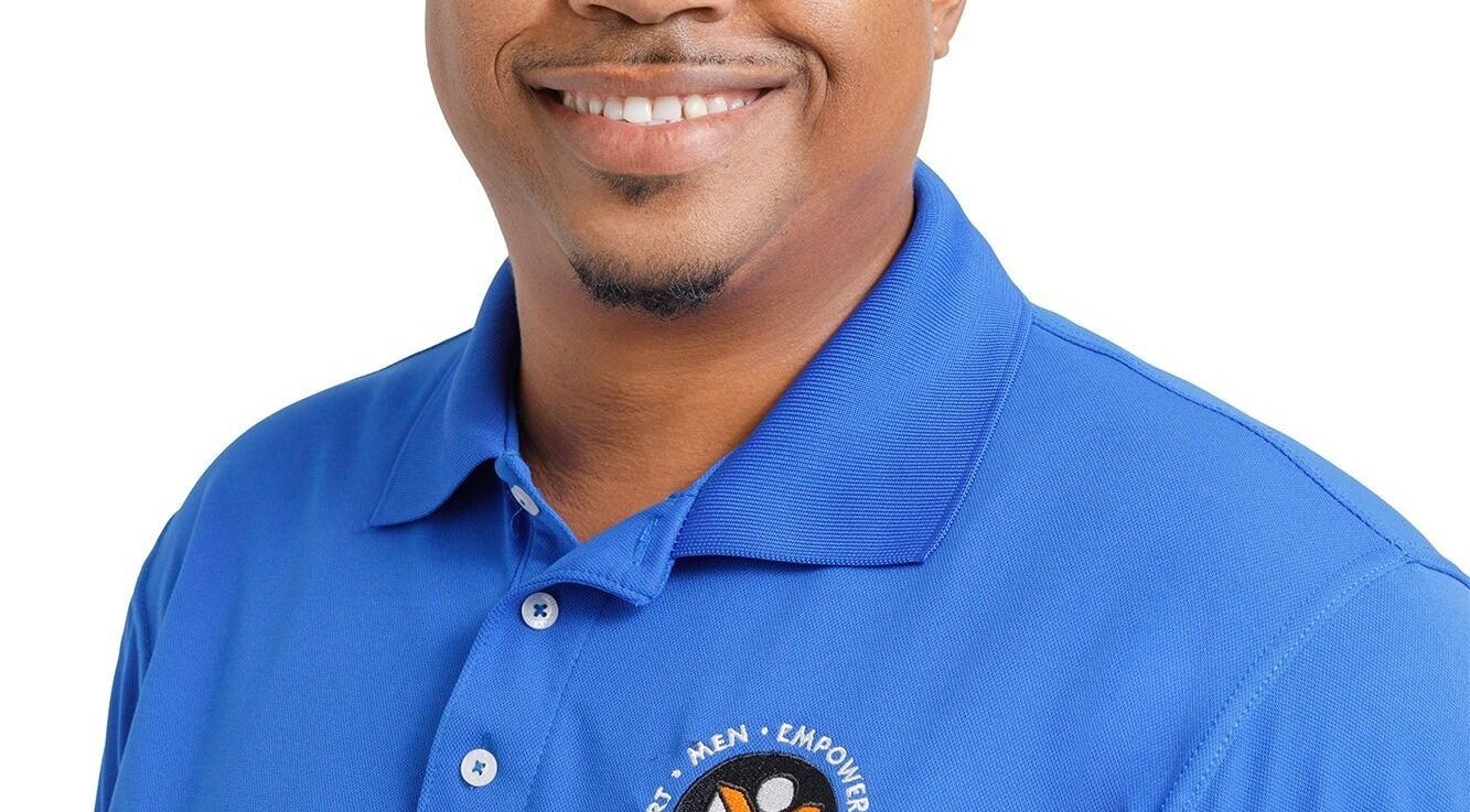 Person in a blue polo with Men Empowerment Network Support logo, Bridgetown, Saint Michael, BB.