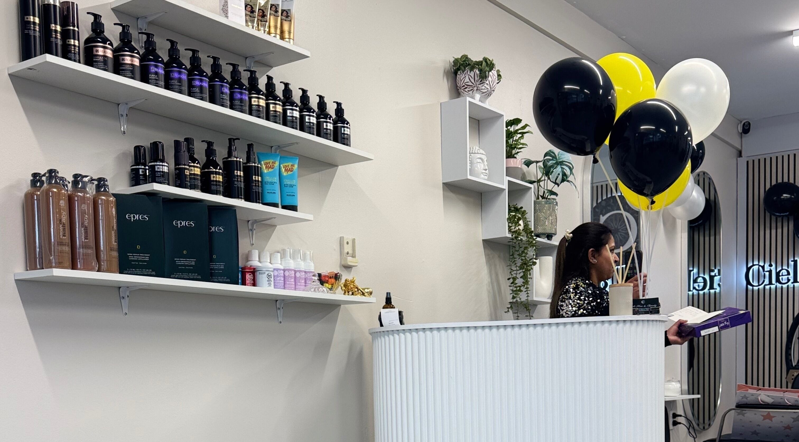 Reception area at Cielo Hair&Beauty, Tauranga. Shelves stocked with hair products and decor.