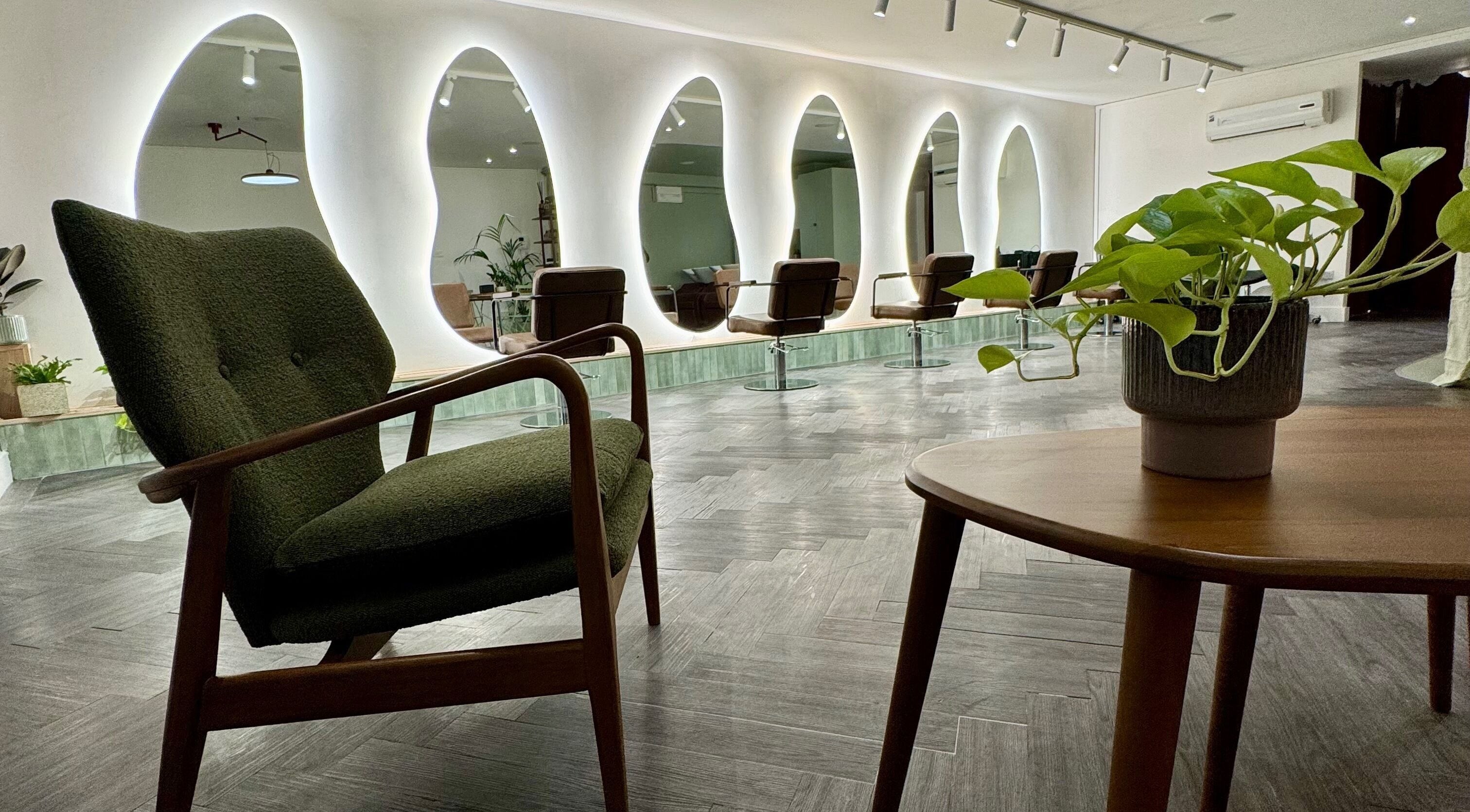 Chic interior of Alto Hair Studio in London, England, featuring stylish chairs and modern mirrors.