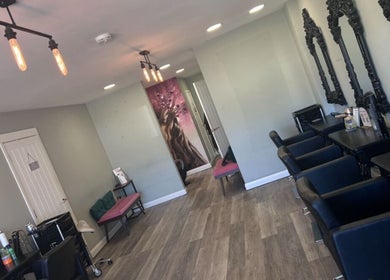 Elegant salon at Harry’s cutz, Kingsbury, England, GB with stylish mirrors and seating areas.