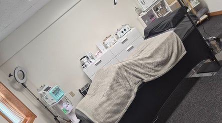 Cozy treatment room at Star Child Esthetics LLC in Midland, Michigan, US with spa bed and skincare equipment.