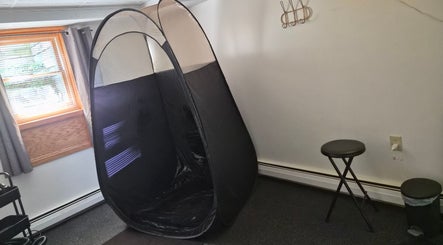 Cozy treatment room at Star Child Esthetics LLC in Midland, Michigan, US featuring a tanning tent.