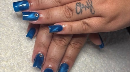 Sapphire blue nails with a rhinestone detail at KT Nails and Esthetics, Lynn, Massachusetts, US.