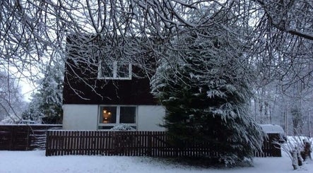 Snow-covered view of Fern & Flow Massage venue in Clydebank, Scotland, GB, enveloped by frosty trees.