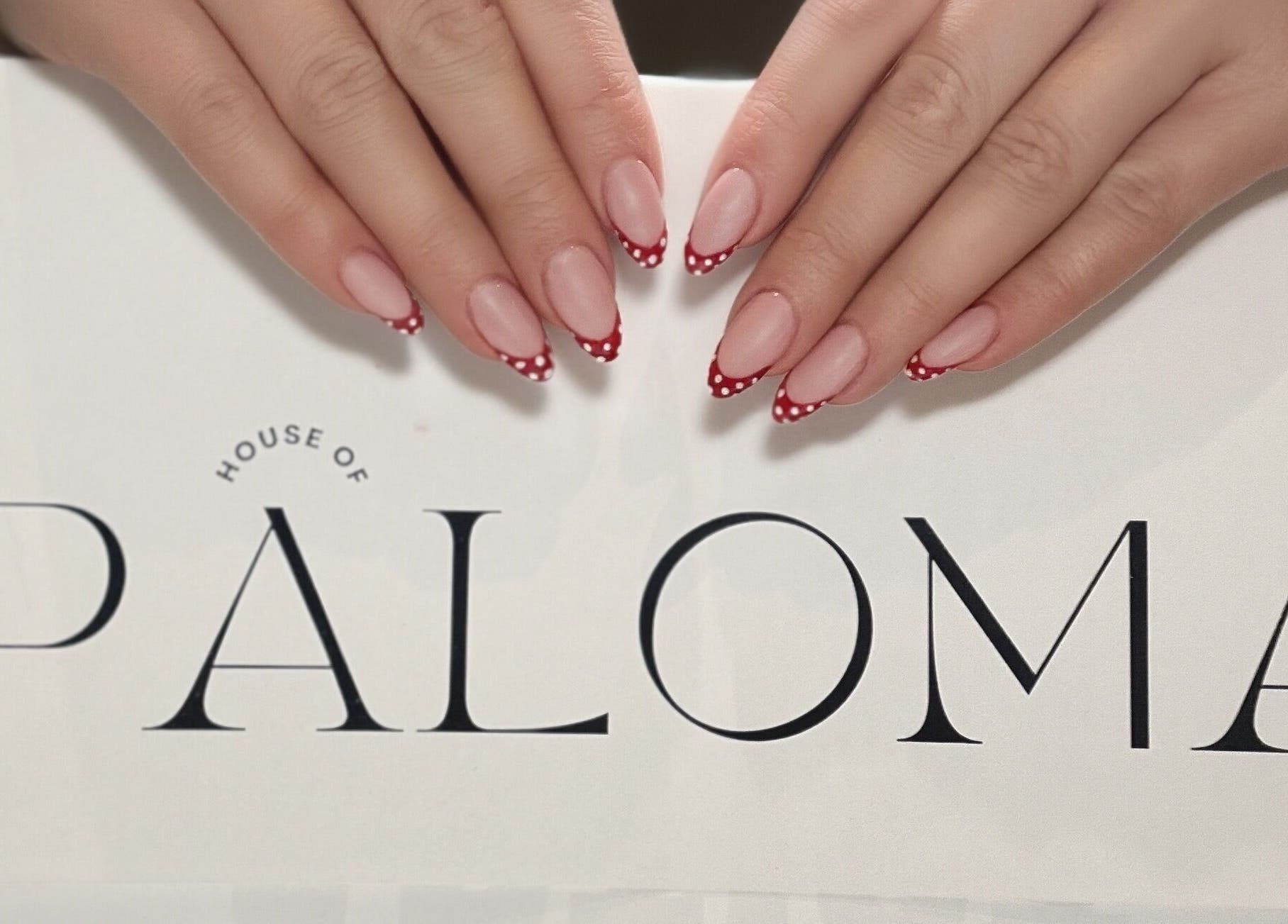 Stylish red-tipped nails at Paloma House Sandbanks, Poole, England, GB, showcasing chic manicure design.