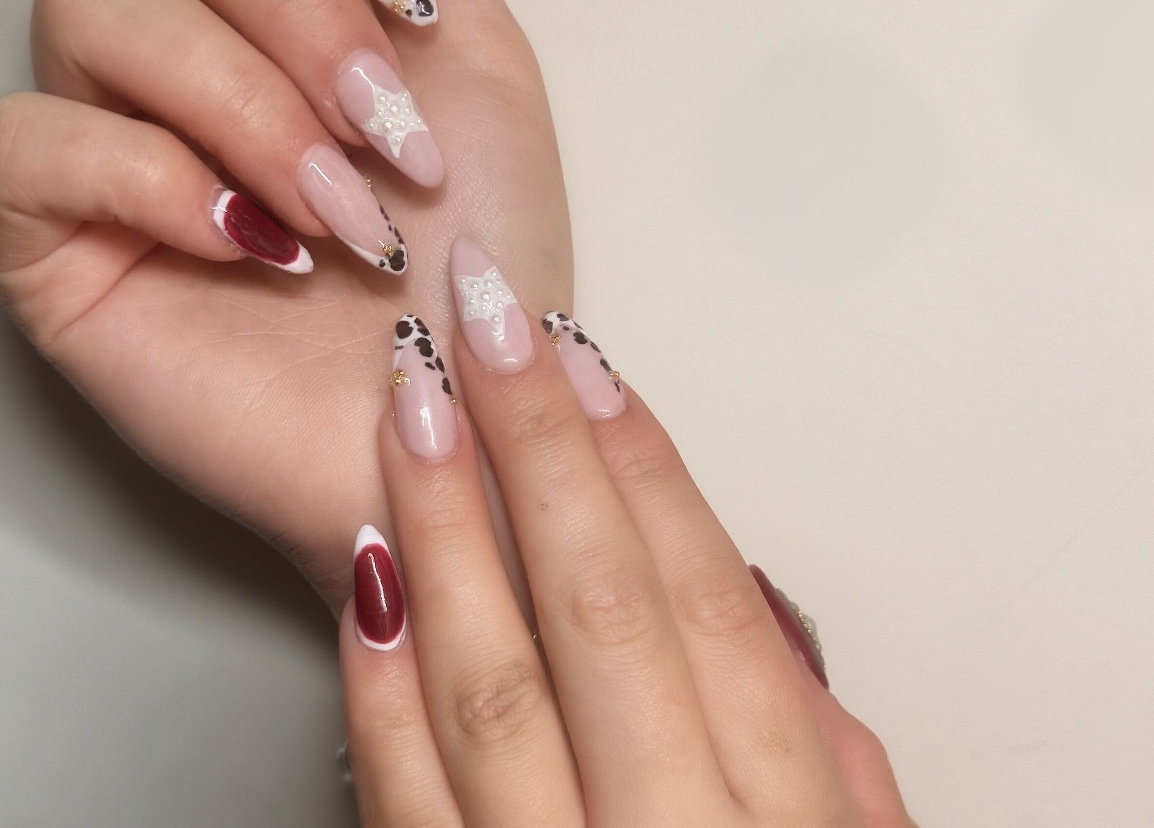 Stylish nail art at Paloma House Sandbanks, Poole, England, GB, featuring detailed designs and vibrant colors.