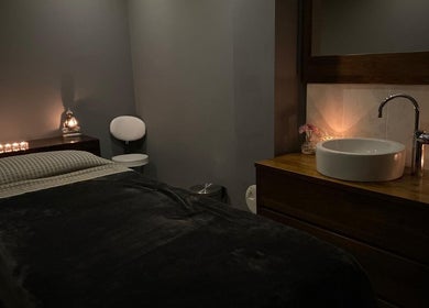 Cozy treatment room at Fairy Tale Therapies Ltd, Edinburgh, Scotland, GB with soft candle lighting.
