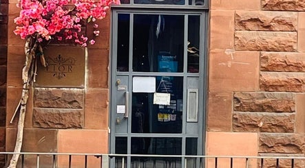 Charming entrance of Fairy Tale Therapies Ltd with blooming flowers, Edinburgh, Scotland, GB.