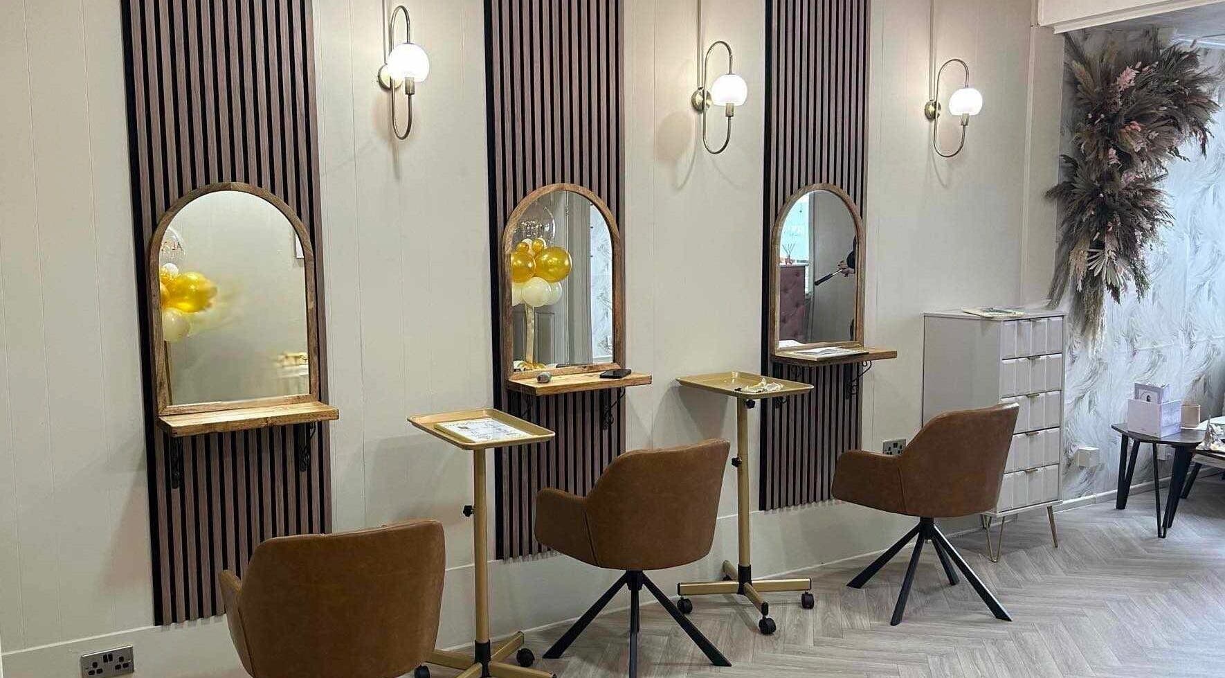 Modern styling stations at Salon 42, Wombwell, England, GB featuring elegant mirrors and seating.
