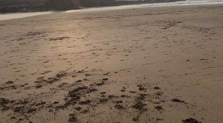 Serene beach view at sunset near Awakening You, Bude, England, GB. Perfect for relaxation and wellness retreats.